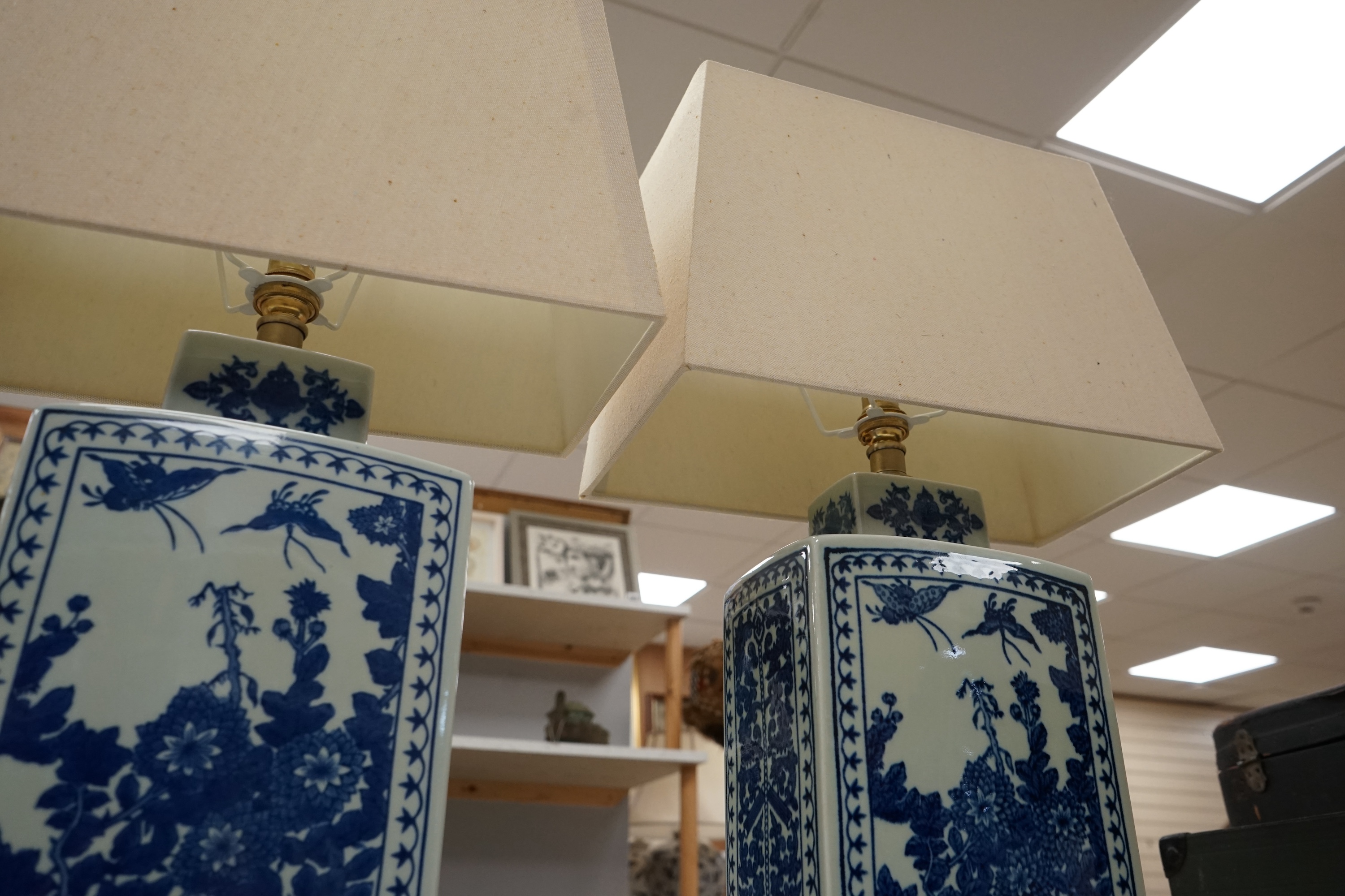 A pair of rectangular profile Japanese blue and white table lamps on stands, with shades, 59cm high. Condition - good